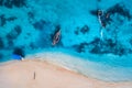 Aerial view of the fishing boats in clear azure water at sunrise