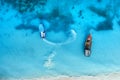 Aerial view of the fishing boats in clear blue water at sunset Royalty Free Stock Photo