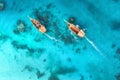 Aerial view of the fishing boats in clear blue water at sunset Royalty Free Stock Photo