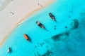 Aerial view of the fishing boats in clear blue water at sunset Royalty Free Stock Photo