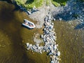 Aerial view of a fishing motor boat in the lake. Beautiful summer landscape with ships. Clear water with sandy and stone beach at Royalty Free Stock Photo