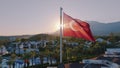 Aerial view of the flag flying on the roof. Sunset. Swimming pool, palm trees and mountains in the background Royalty Free Stock Photo