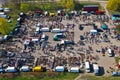 Aerial view on flea market with miscellaneous items and crowds of buyers and seller`s makeshift stands