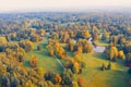 Aerial view flight over autumn valley park with meadows and a winding river, ponds, bright trees Royalty Free Stock Photo