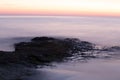 Aerial view of a floating layer of clouds over rocky mountains and cliffs at sunset Royalty Free Stock Photo