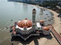 Aerial view floating mosque and fishing boats nearby.