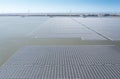 Aerial view of Floating solar power plant and wind turbine farm