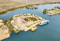 Aerial view of floating village in Uros islands at Titicaca lake in Peru - Wanderlust and travel concept - Cloudy aftrenoon