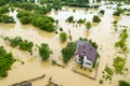 Aerial view of flooded house with dirty water all around it