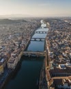 Aerial view of Florence skyline along Arno river at sunset with Ponte Vecchio bridge in foreground, Florence, Tuscany, Italy Royalty Free Stock Photo