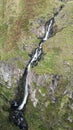 Aerial view of the flowing Corrie Spout Waterfall in rural Scotland