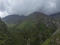 Aerial view flying through cloud covered mountains in Alamedin Gorge, Kyrgyzstan