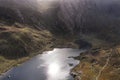 Aerial view of flying drone Epic dramatic Autumn landscape image of Llyn Idwal in Devil`s Kitchen in Snowdonia National Park with