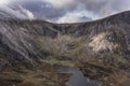 Aerial view of flying drone Epic dramatic Autumn landscape image of Llyn Idwal in Devil`s Kitchen in Snowdonia National Park with