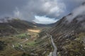 Aerial view of flying drone Epic landscape image in Autumn looking down Nant Fracon valley from Llyn Idwal with moody sky and Royalty Free Stock Photo