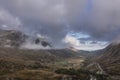 Aerial view of flying drone Epic landscape image in Autumn looking down Nant Fracon valley from Llyn Idwal with moody sky and Royalty Free Stock Photo