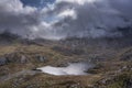 Aerial view of flying drone Epic landscape image of Llyn Bochlwyd in the mountains in Snowdonia National Park with dramatic sky Royalty Free Stock Photo