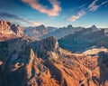 Aerial view from flying drone of winding Giau pass road with Ra Gusela peak.