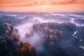 Aerial view of foggy forest at colorful sunrise in autumn Royalty Free Stock Photo