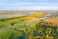 Aerial view of foggy forest and meadows at colorful sunrise in autumn. Beautiful landscape with trees in fog, river, fields and Royalty Free Stock Photo