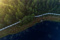 An aerial view of foggy morning in Mukri bog in Estonia with some small bog lakes and islands in Northern Europe.