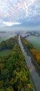 Aerial view of foggy trees in field at colorful sunrise in autumn. Colorful landscape with forest in low clouds, river Royalty Free Stock Photo