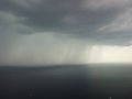 Aerial view footage of rain clouds over sea ocean Black clouds in bad weather day over sea surface High angle view Royalty Free Stock Photo