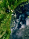 Aerial view of sauna house by the lake shore. Wooden pier with fishing boats. Royalty Free Stock Photo