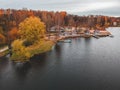Aerial view of forest and blue lake. Sauna house by the lake shore. Wooden pier with fishing boats. St. Petersburg, Russia Royalty Free Stock Photo