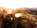 Aerial view of forest and green grassland at sunset. Royalty Free Stock Photo