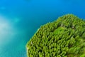 Aerial view of a forest lake. Aerial view of blue lake and green forests on a sunny summer day. Drone photography. Forest and lake