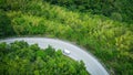 Aerial view forest nature with car on the road on the mountain green tree background, top view road curve from above countryside Royalty Free Stock Photo