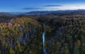 Aerial view of forest with red trees on mountain in fall in Slovakia. Colorful landscape. Top view from drone. Nature in october Royalty Free Stock Photo
