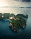 Aerial view of a forested green rocky island with a sandy beach in Thailand, Krabi, Ko Hong