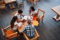 Aerial view. Four young students in casual clothes have meeting at rainy day