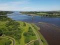 Aerial view of the Foyle Bridge in Londonderry, Northern Ireland with a calm river and lush greenery Royalty Free Stock Photo