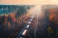 Aerial view of freight train in autumn forest in fog at sunrise Royalty Free Stock Photo