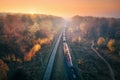 Aerial view of freight train in autumn forest in fog at sunset Royalty Free Stock Photo
