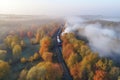 Aerial view of freight train in beautiful forest in fog at sunrise in autumn. Colorful landscape with railroad Royalty Free Stock Photo