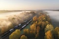Aerial view of freight train in beautiful forest in fog at sunrise in autumn. Colorful landscape with railroad Royalty Free Stock Photo