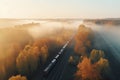 Aerial view of freight train in beautiful forest in fog at sunrise in autumn. Colorful landscape with railroad Royalty Free Stock Photo