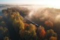 Aerial view of freight train in beautiful forest in fog at sunrise in autumn. Colorful landscape with railroad Royalty Free Stock Photo