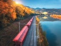 Aerial view of freight train moving near river in mountains Royalty Free Stock Photo