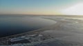 Aerial view of frozen Dnieper estuary. Dark water that is partially covered with ice and large chunks of ice.