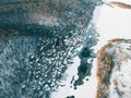 Aerial view of frozen river in snow and small village with houses and forest, view from drone as abstract winter background Royalty Free Stock Photo