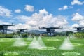 Aerial view futuristic agricultural drone,spraying chemicals or organic fertilizers into water droplets in agricultural areas