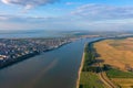 Aerial view of Galati City, Romania. Danube River near city with sunset warm light