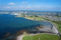 Aerial view on Galway city and Ballyloughane Strand. Warm sunny day. Blue sky and water of the ocean. High tide. Residential area Royalty Free Stock Photo