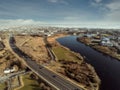 Aerial view on Galway city. Road N6. Galaway city, Ireland. Warm sunny day. Cloudy sky. Warm and cool tone. Boat moving in river Royalty Free Stock Photo