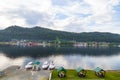 Aerial view of the gazebos in the Altai Mountains on the shore of Lake Teletskoye with three boat moored near the shore river with